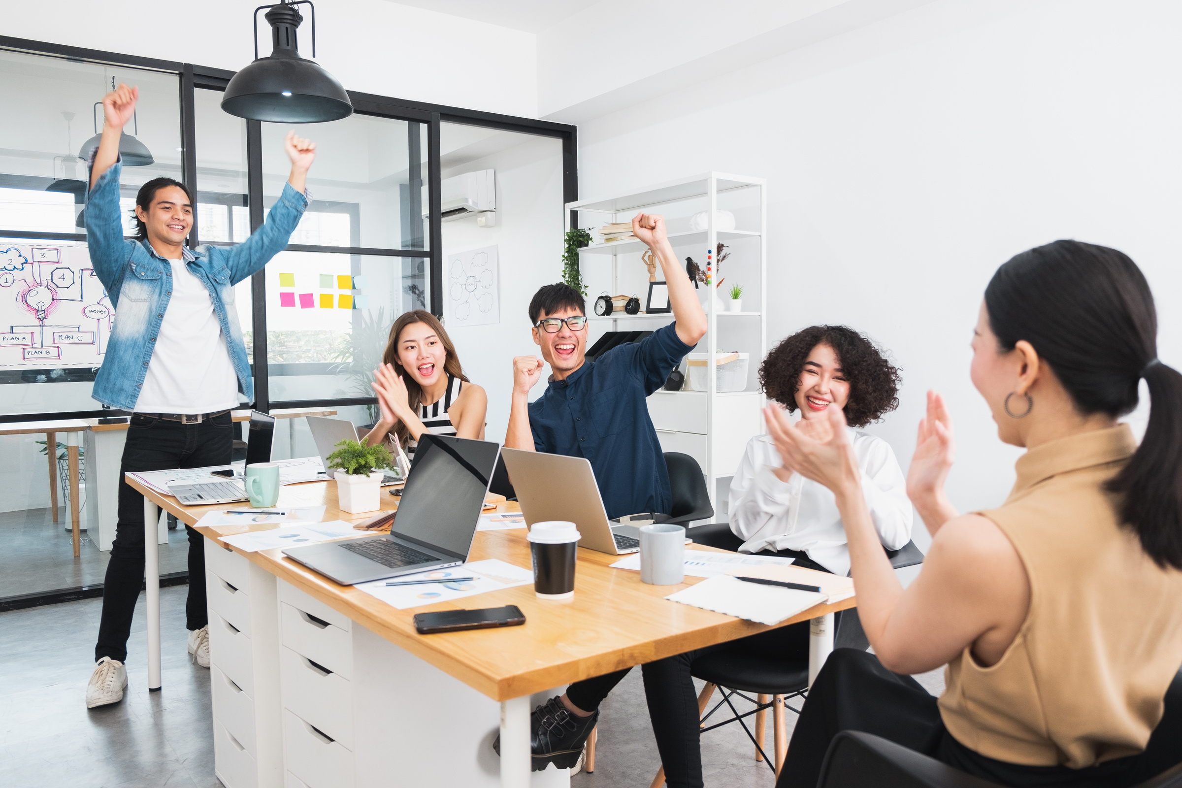 Happy Asian business people working in office